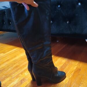 Two knee high boots one is with a high heel and the other wedges high heel boots
